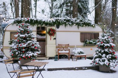 Festive atmosphere - lights, red blankets, Christmas trees. Caravan camping. mobile home trailer clipart