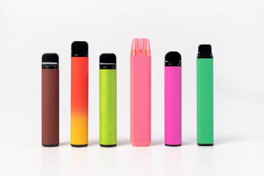 A set of colorful disposable electronic cigarettes of different shapes on a white background. modern smoking