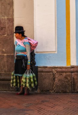Quito, Ecuador - 24 November 2022: Traditional woman street vendor at historic center of Quito, Ecuador.