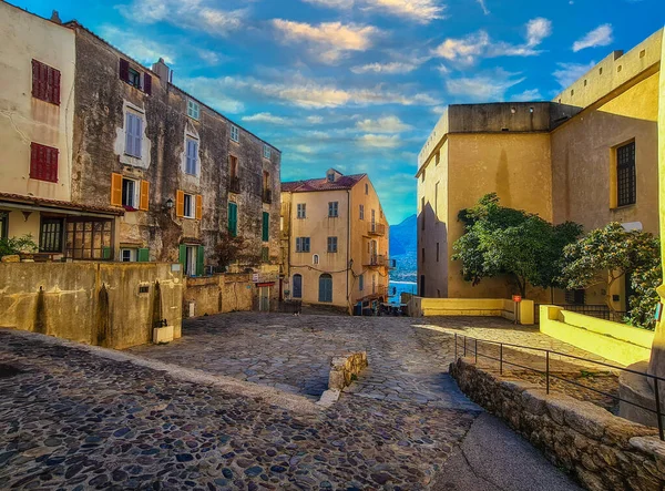 Street with historic houses in Calvi old town, Corsica island, France