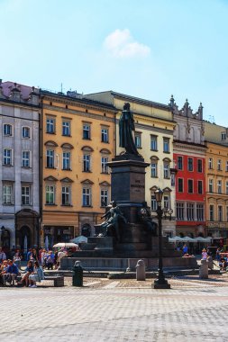 Krakow, Poland - 12 August 2022:View of the main square in Krakow with the statue of Adamowi Narod