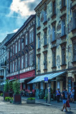 Krakow, Poland - 12 August 2022: Joseph Street in Kazimierz district in Krakow, former jewish quarter. Nowadays it is a popular area for the visitors of Krakow as well as the local people.