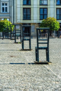 sculptures of chairs in memory of around a thousand people of the Jewish community shot dead by the Nazis during March 1943 on Bohaterow Getta, Krakow, Poland