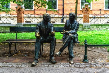 Krakow, Poland - 13 August 2022:  Statue of the Otto Nikodym and Stefan Banach Memorial Bench, both mathematicians, sculpted by Stefan Dousa in Krakow