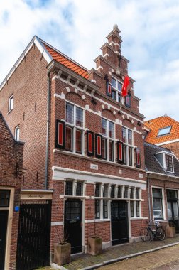 old town house of cobblestone with clear blue sky. Antique, traditional row house in the Netherlands. clipart