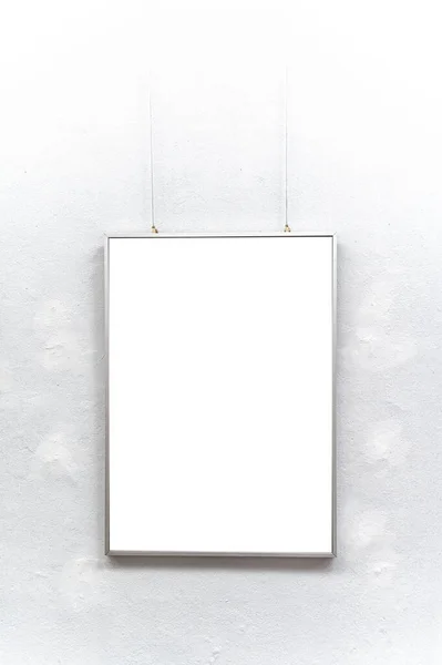 Empty picture frame hanging on white wall.