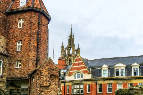 stock image Cathedral spire of St Nicholas church in centre of Newcastle upon Tyne North East England with classical Victorian building facade in foreground