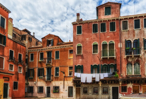 Laundry hanging out of typical Venetian facade,Italy.