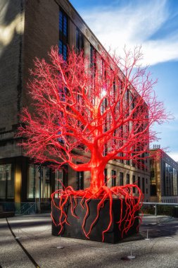 New York, United States - 22 December 2023: Bright red-and pink art installation Old Tree by Pamela Rosenkranz on the High Line Plinth at the Spur at 30th street and 10th Avenue clipart