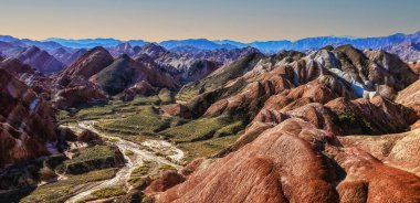 Amazing scenery of Rainbow mountain and blue sky background in sunset. Zhangye Danxia National Geopark, Gansu, China. Colorful landscape, rainbow hills, unusual colored rocks, sandstone erosion clipart