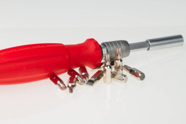 Screwdriver with various size sockets on white background