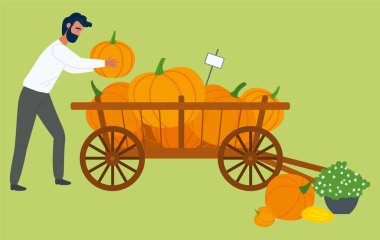 Sonbahar hasadı, insan ve balkabağı el arabası taşıyıcısı. Ahşap arabadaki sebzeler, market ve satıcı, çiftlik yiyeceği, organik beslenme ve tarım. Cadılar Bayramı için Balkabağı