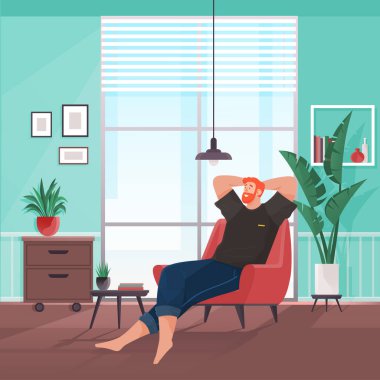 Young man sitting and chilling on armchair. Man is resting at home, leisure on weekend. Freelancer relaxing after work. Hipster in jeans and t-shirt. Relaxed guy thinking about something good