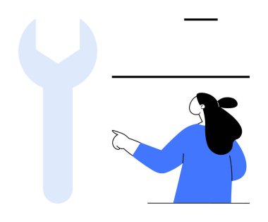 Mavi bluzlu bir kadın, büyük bir ingiliz anahtarını işaret ediyor. Eğitici materyaller için ideal. Makine mühendisliği atölyeleri, problem çözme araçları ve görsel iletişim için.