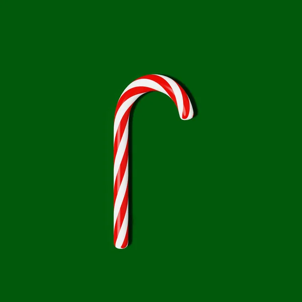 Christmas candy cane 3D rendering green background. Christmastide lollipop caramel stick Festive ornaments Xmas Saint Nicholas Day Winter holiday seasonal decoration flat lay design element copy space