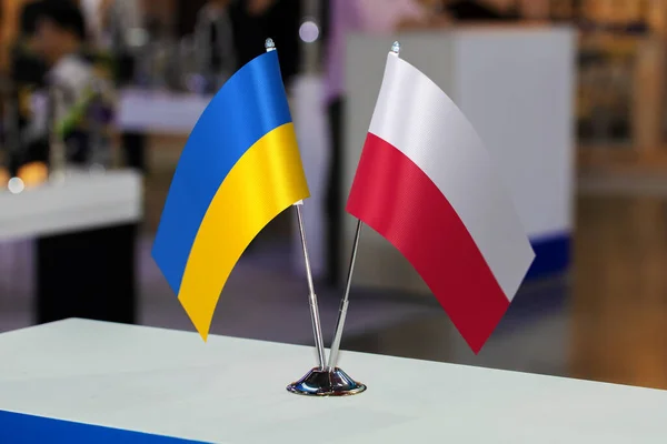 Flags of Ukraine and Poland together at some event or fair. Flags of the two countries as a symbol of cooperation between the two states. Joint business of Poland and Ukraine.