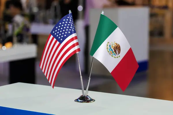 Two table flags of the USA and Mexico together at some event or fair, as a symbol of cooperation between the two states. Joint business of the United States of America and the United Mexican States.