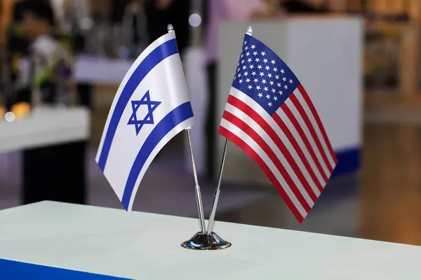 Tabletop flags of Israel and the United States of America together at some event or fair. Flags of two countries as a symbol of cooperation between states. Joint business between the USA and Israel.