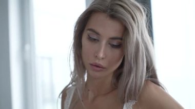 This stock video shows a beautiful girl in sexy erotic lingerie, slow motion