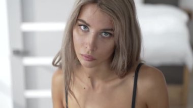 This stock video shows a beautiful girl in sexy erotic lingerie, slow motion