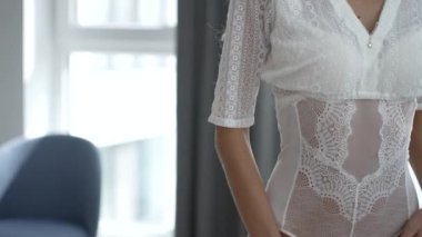 This stock video shows a beautiful girl in sexy erotic lingerie, slow motion