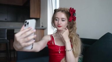 This stock video shows a young girl taking a selfie on her phone, slow motion