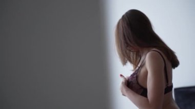 This stock video shows a beautiful woman in sexy lingerie