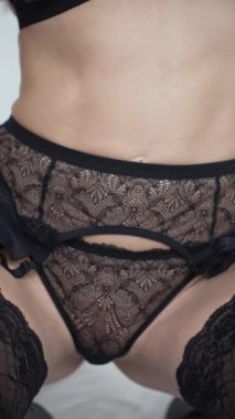 This stock vertical video shows a woman in sexy lingerie, slow motion