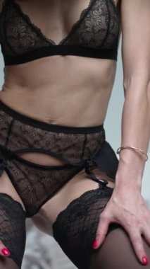 This stock vertical video shows a woman in sexy lingerie, slow motion