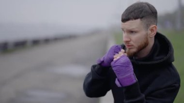 Erkek boksör şehirde spor eğitimi alıyor.