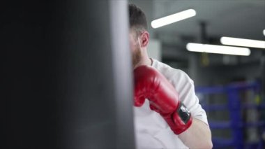 Spor salonunda antrenman yaparken erkek boksör, 8K 'da ağır çekim.