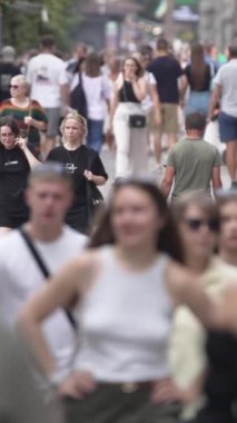 KYIV, UKRAINE  SEPTEMBER 1, 2024 : Vertical video of a crowd of people on a city street