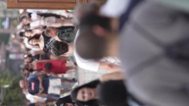 KYIV, UKRAINE - 30 Ağustos 2024: Yazın kalabalık bir şehir caddesinin dikey videosu