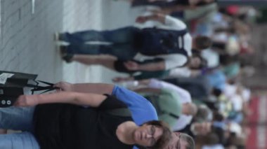 KYIV, UKRAINE - 30 Ağustos 2024: Yazın yürüyen kalabalığın dikey videosu