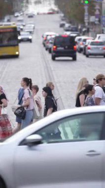 KYIV, UKRAINE 21 Ekim 2024: Yaya geçidindeki bir kalabalığın dikey videosu, yavaş çekim
