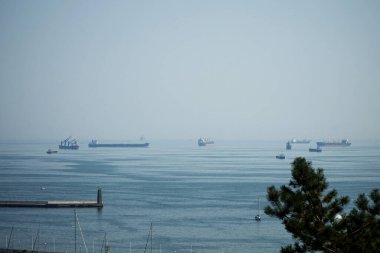 Ships drift near the port of the city of Gdynia, waiting for unloading or loading.