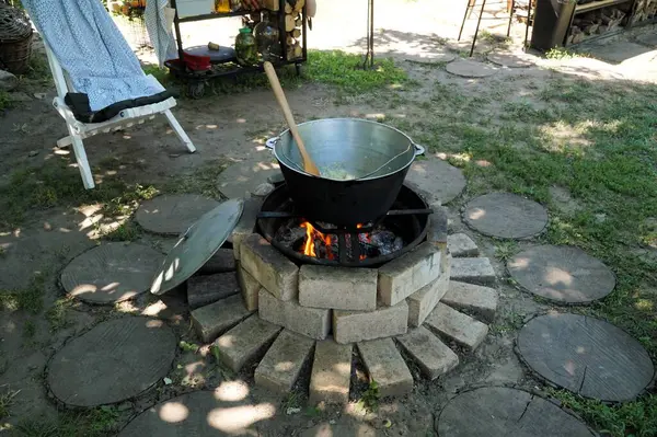 Stock image A cauldron of food that is cooked on fire