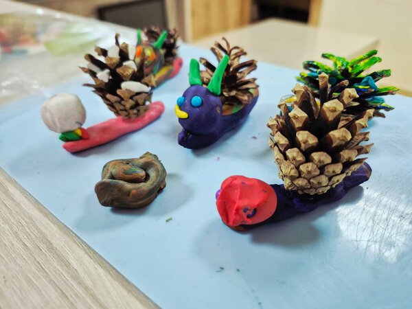 Children's crafts made of plasticine on paper.