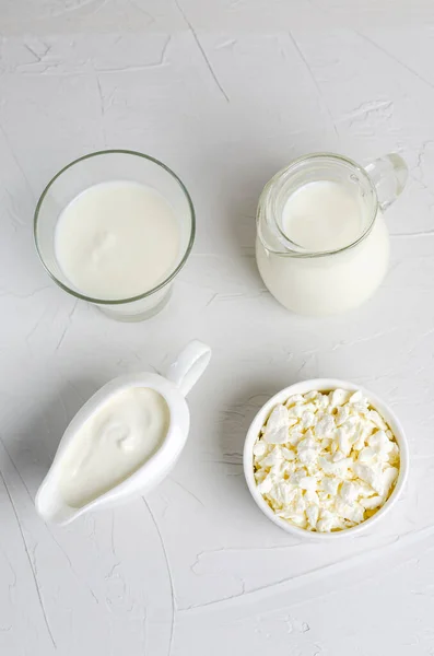 Homemade fermented milk products - kefir, sour cream, cottage cheese on a white background. Sour milk drink, sourdough for yeast bacterial fermentation, intestinal health concept.