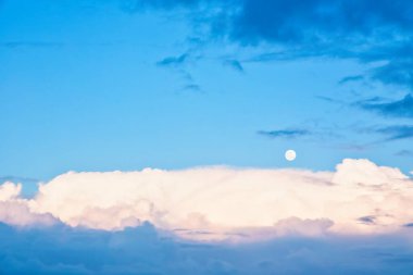 Yeni Zelanda 'nın gökyüzü masmavi gökyüzü, beyaz bulutlar ve ayın yer değiştirmesi.