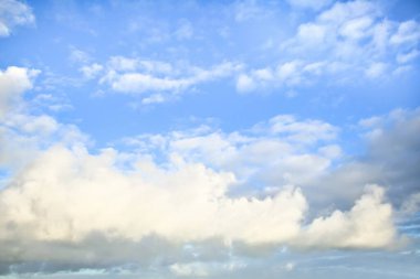 Arkalarında açık mavi gökyüzü olan açık gri kabarık bulutların gökyüzü yedeği.