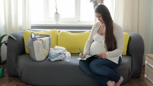 Cute Pregnant Woman Writing Packing List Maternity Hospital Notebook Prepares — Stock Video
