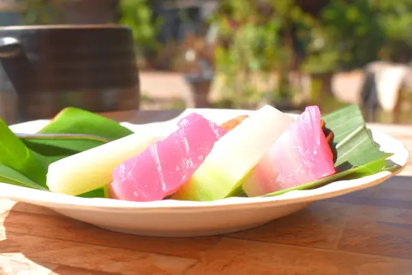 色彩艳丽的泰国菜甜食白盘绿色香蕉叶蒸笼蛋糕特写 — 图库照片