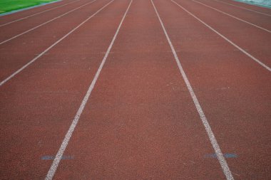 Empty fast running lane in outdoor sport stadium running track