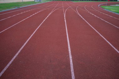 Empty fast running lane in outdoor sport stadium running track