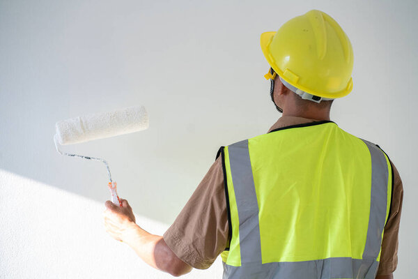 Men paint indoor color with roller paint on white background