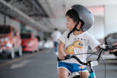Preschool boy learn to rude bicycle wear helmet exercise activity