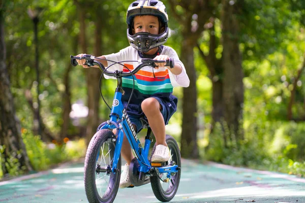 stock image Kindergarten boy practice ride bicycle in city park bike lane