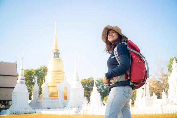 Solo travel backpack women travel in buddhist temple in Chiangmai Thailand