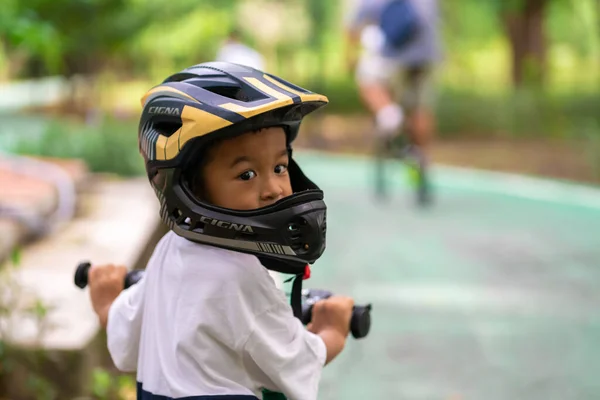 stock image Little kindergarten boy ride a bike in public park outdoor activity